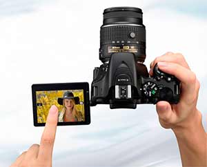 Photo of the D5500 DSLR with NIKKOR lens and image of a blonde woman on the LCD